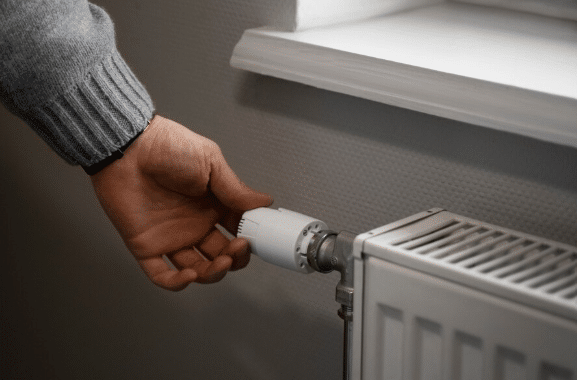 Image of someone adjusting their radiator.