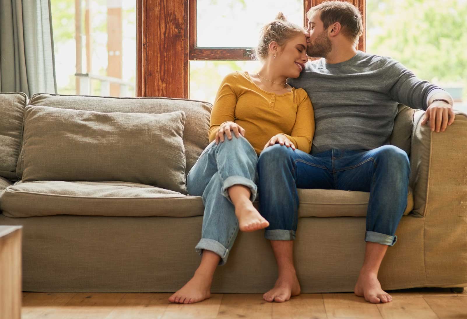 A couple sitting on the couch, enjoying their radiant heated floor.