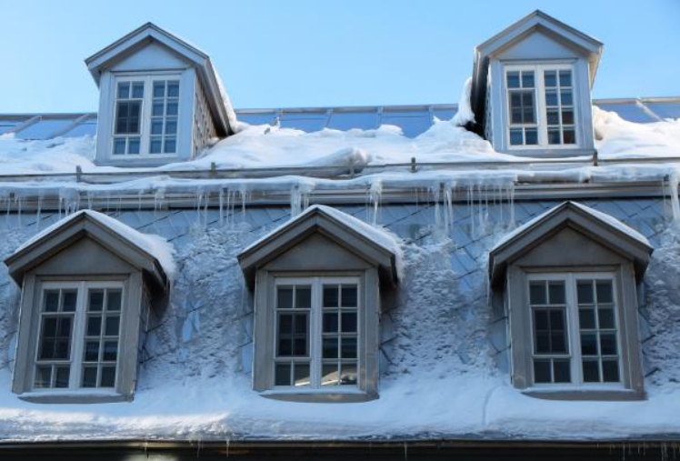 Up-close image of asphalt roof texture with roof heating cable installed.