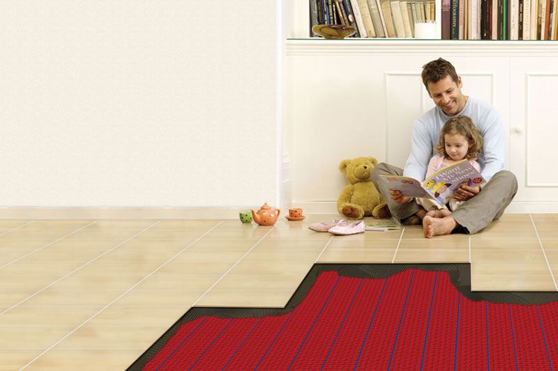 A man and a child sitting on floor with underfloor radiant heating.