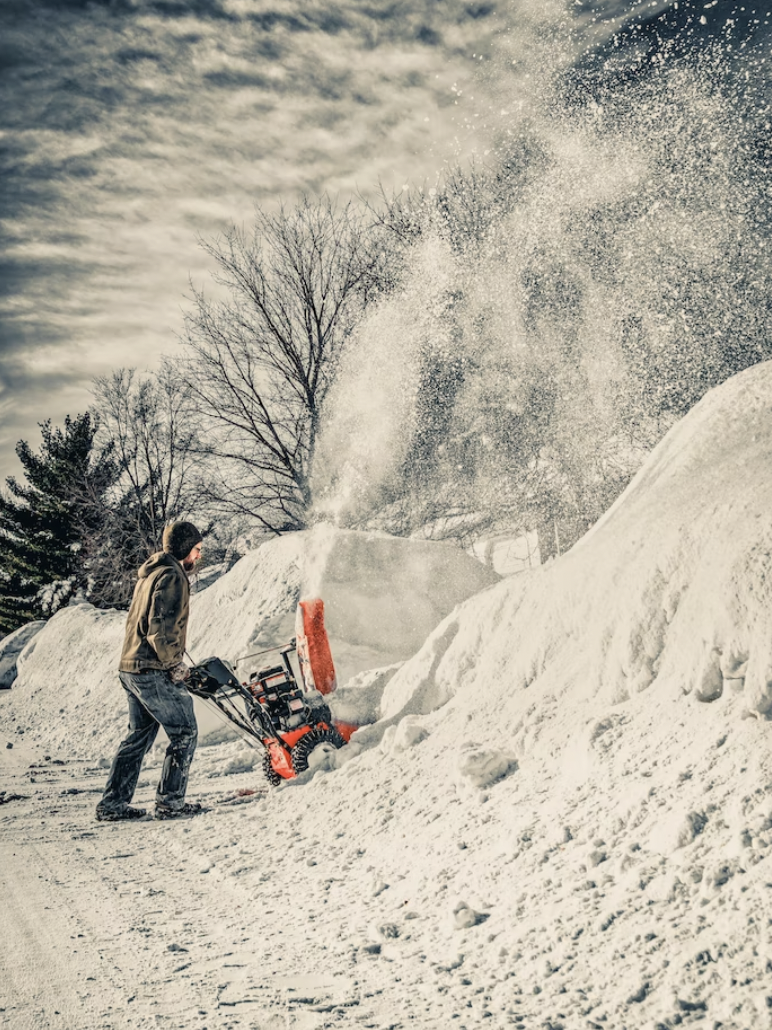 A person using a snow blower for snow removal.