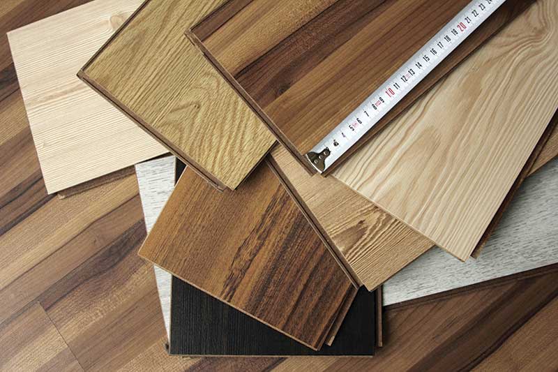 Multiple planks of hardwood in a pile.